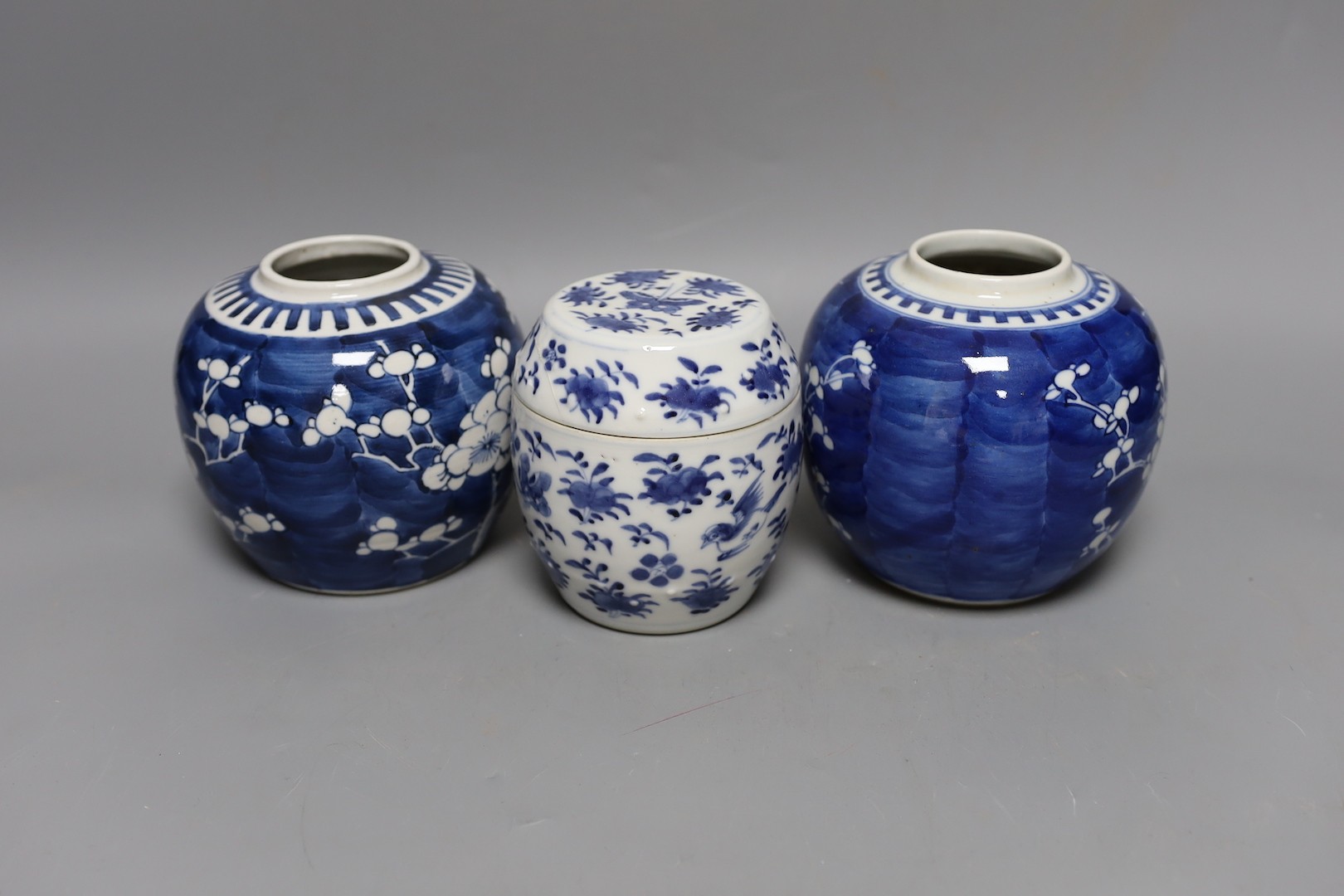 Two 19th century blue and white prunus jars and a barrel jar and cover. 12cm